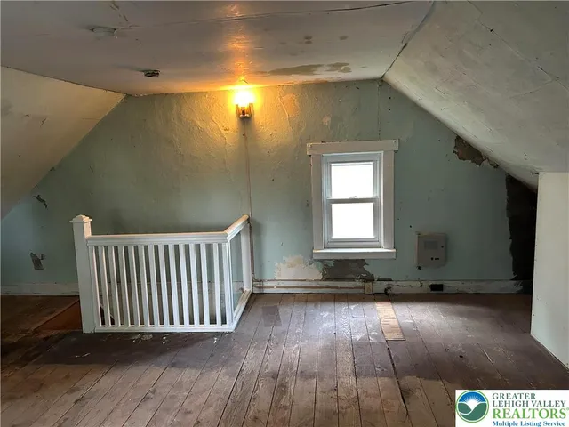 a view of a room with wooden floor