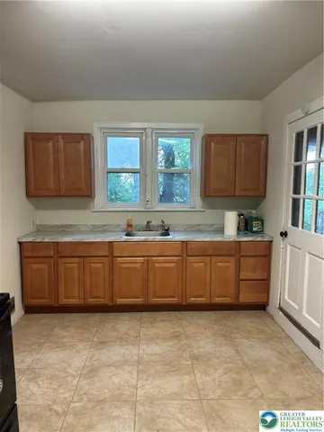 a kitchen with sink cabinets and window