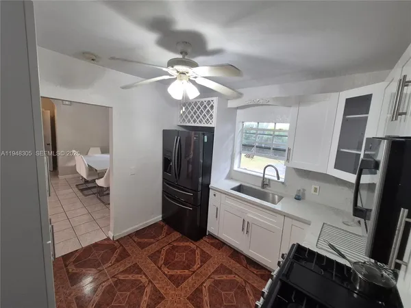 a kitchen with a sink appliances and cabinets