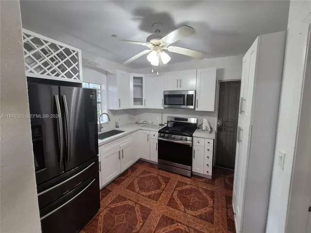 a kitchen with stainless steel appliances granite countertop a refrigerator stove and microwave