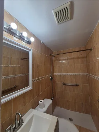 a bathroom with a shower and a sink