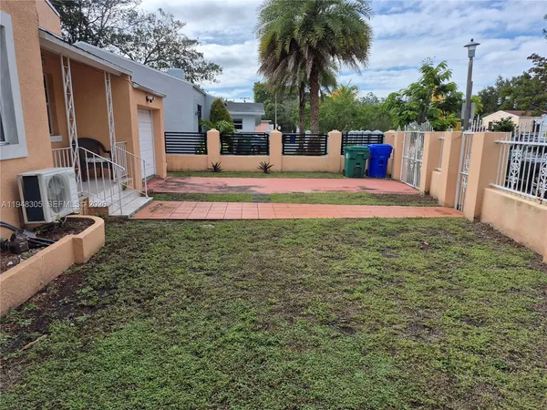 a view of a house with backyard and a patio