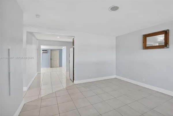 a view of an empty room with a closet