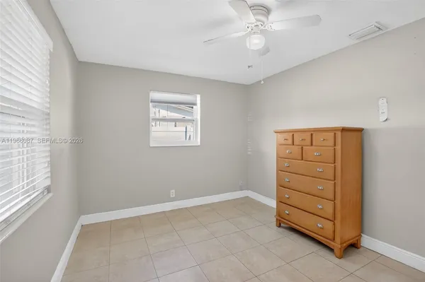 a view of room with cabinet and ceiling fan
