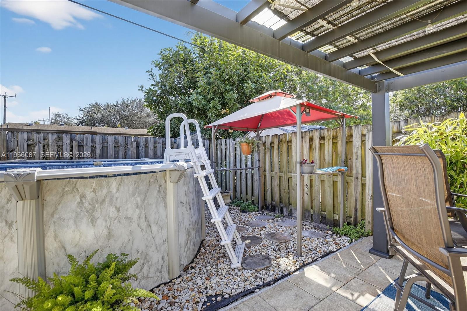 4998 Southwest 92nd Terrace Cooper City, FL 33328 - Photo 30 of 47 a view of a roof deck with wooden floor and fence next to a yard
