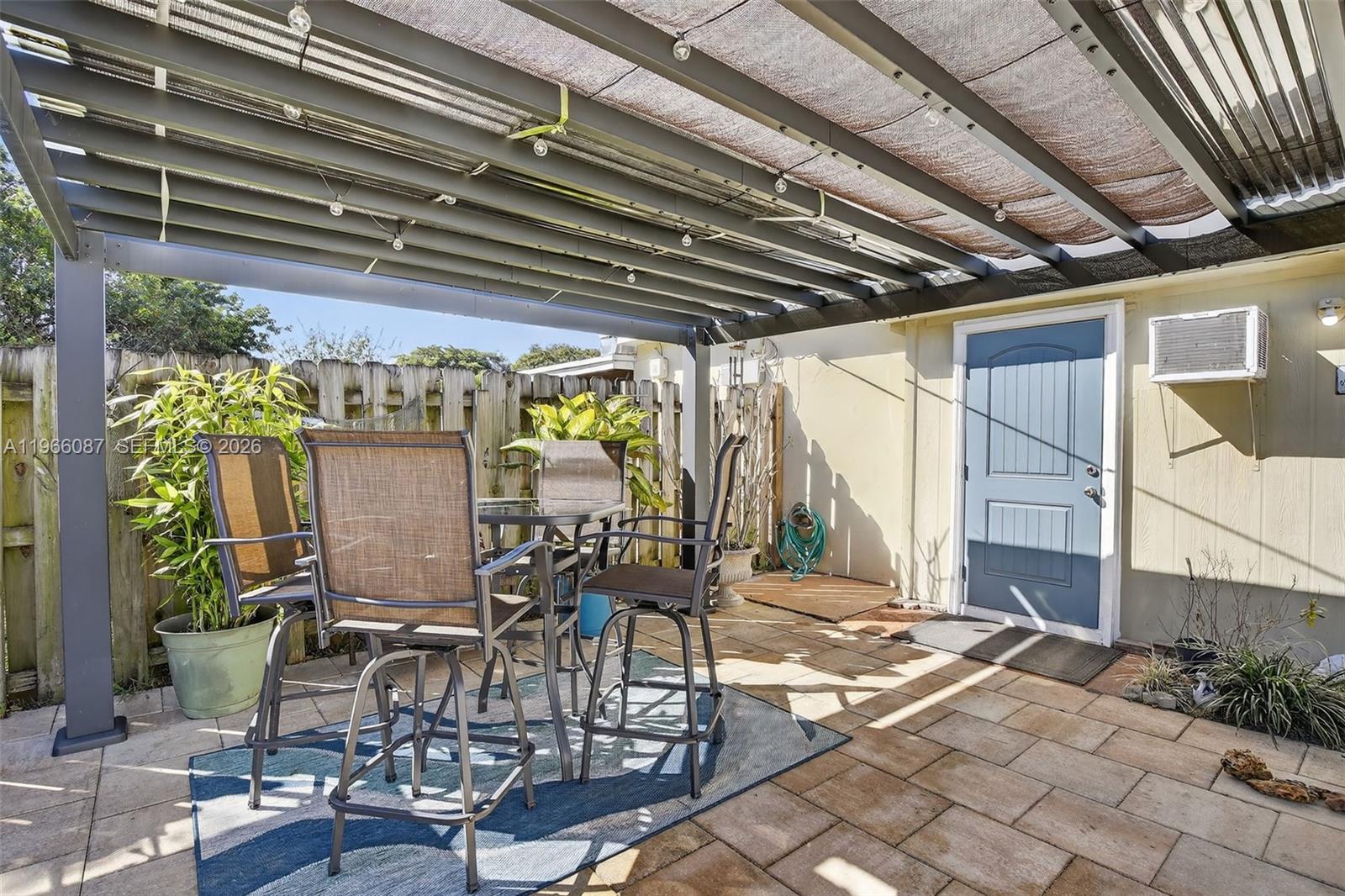 4998 Southwest 92nd Terrace Cooper City, FL 33328 - Photo 31 of 47 a view of a patio with table and chairs and potted plants