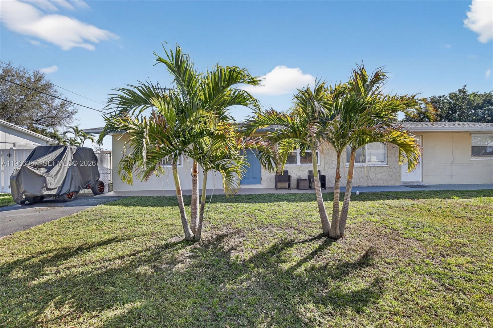 4998 Southwest 92nd Terrace Cooper City, FL 33328 - Photo 36 of 47 a palm tree sitting in front of a house with a yard