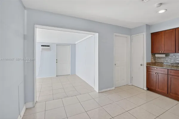 a kitchen with granite countertop a refrigerator and a sink
