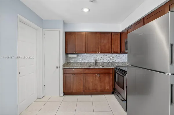 a kitchen with a refrigerator sink and microwave
