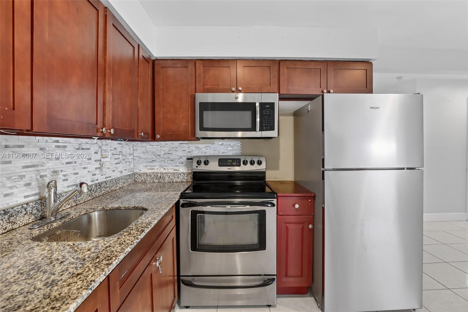 4998 Southwest 92nd Terrace Cooper City, FL 33328 - Photo 9 of 47 a kitchen with a refrigerator sink and microwave