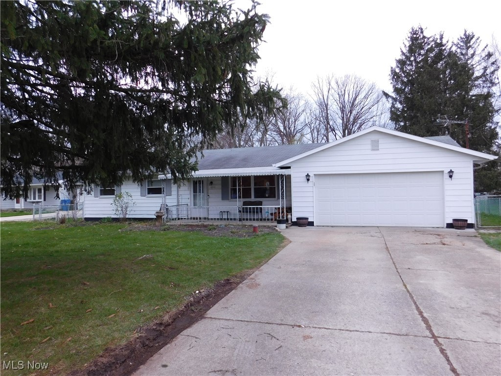 8754 Root Road North Ridgeville, OH 44039 - Photo 35 of 39 Ranch-style home featuring driveway, a front lawn, a garage, and a porch