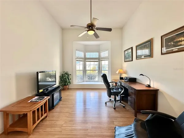 a view of a livingroom with furniture hardwood floor and a window