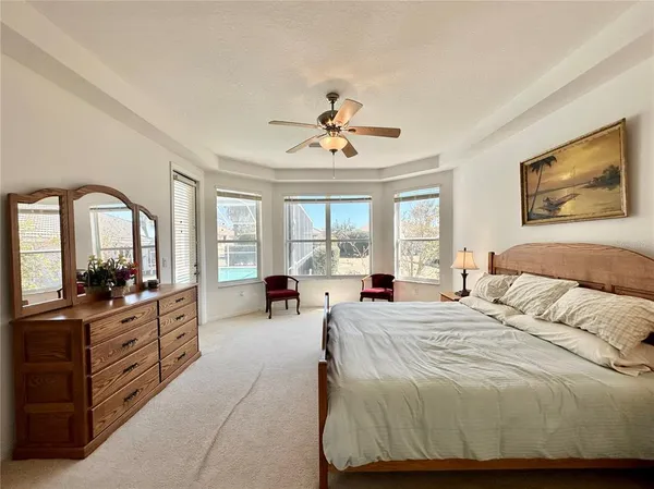 a bedroom with a bed and glass windows