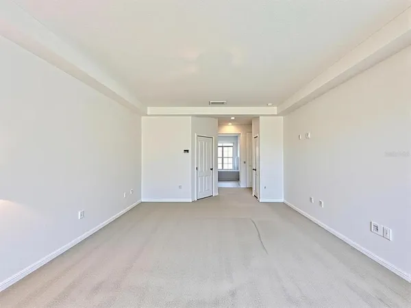 a view of an empty room with closet area