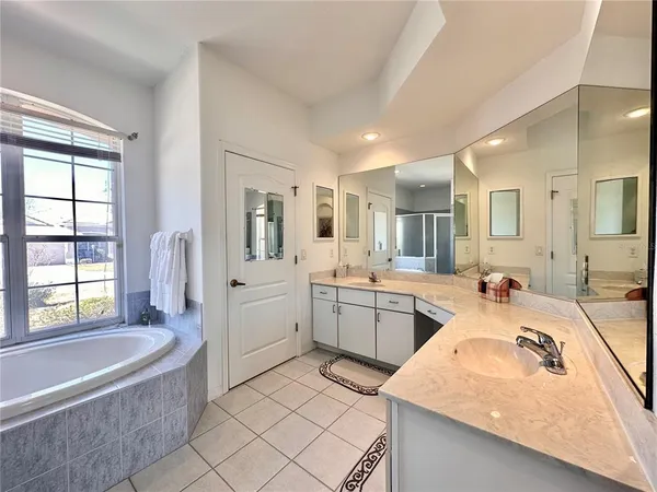 a large white kitchen with a large window