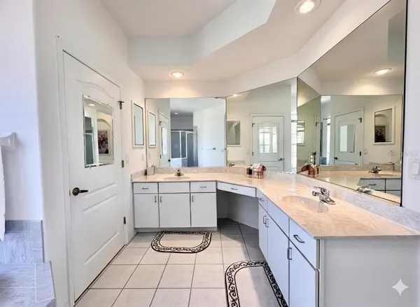 a large white kitchen with a sink and cabinets