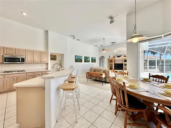 a living room with stainless steel appliances kitchen island granite countertop furniture and a kitchen view