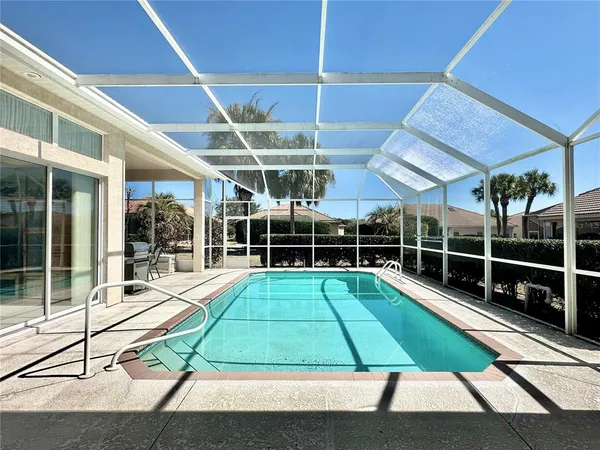 a room with pool table and glass windows