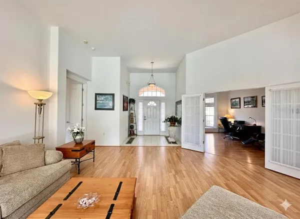 a living room with furniture and a chandelier
