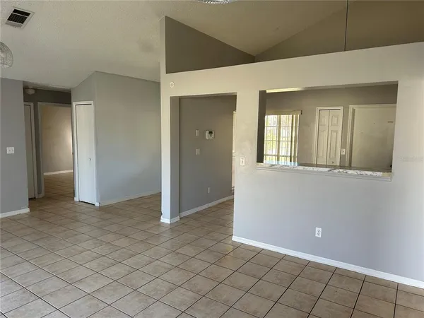 a kitchen with a refrigerator a stove top oven and cabinets