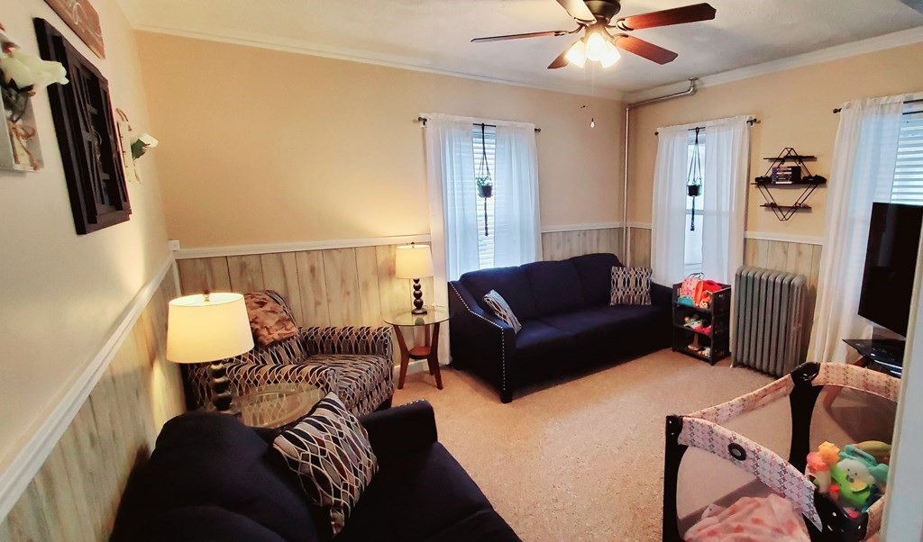 13 Whipple Street Worcester, MA 01607 - Photo 7 of 17 a living room with furniture a ceiling fan and a rug