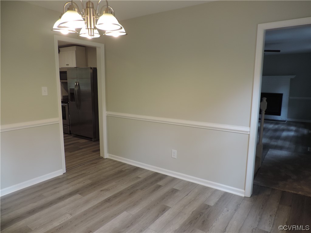 7517 Drexelbrook Road Chesterfield, VA 23832 - Photo 8 of 29 an empty room with wooden floor chandelier and windows