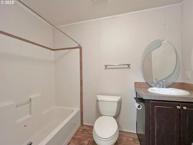 a white toilet sitting next to a bathroom sink and tub