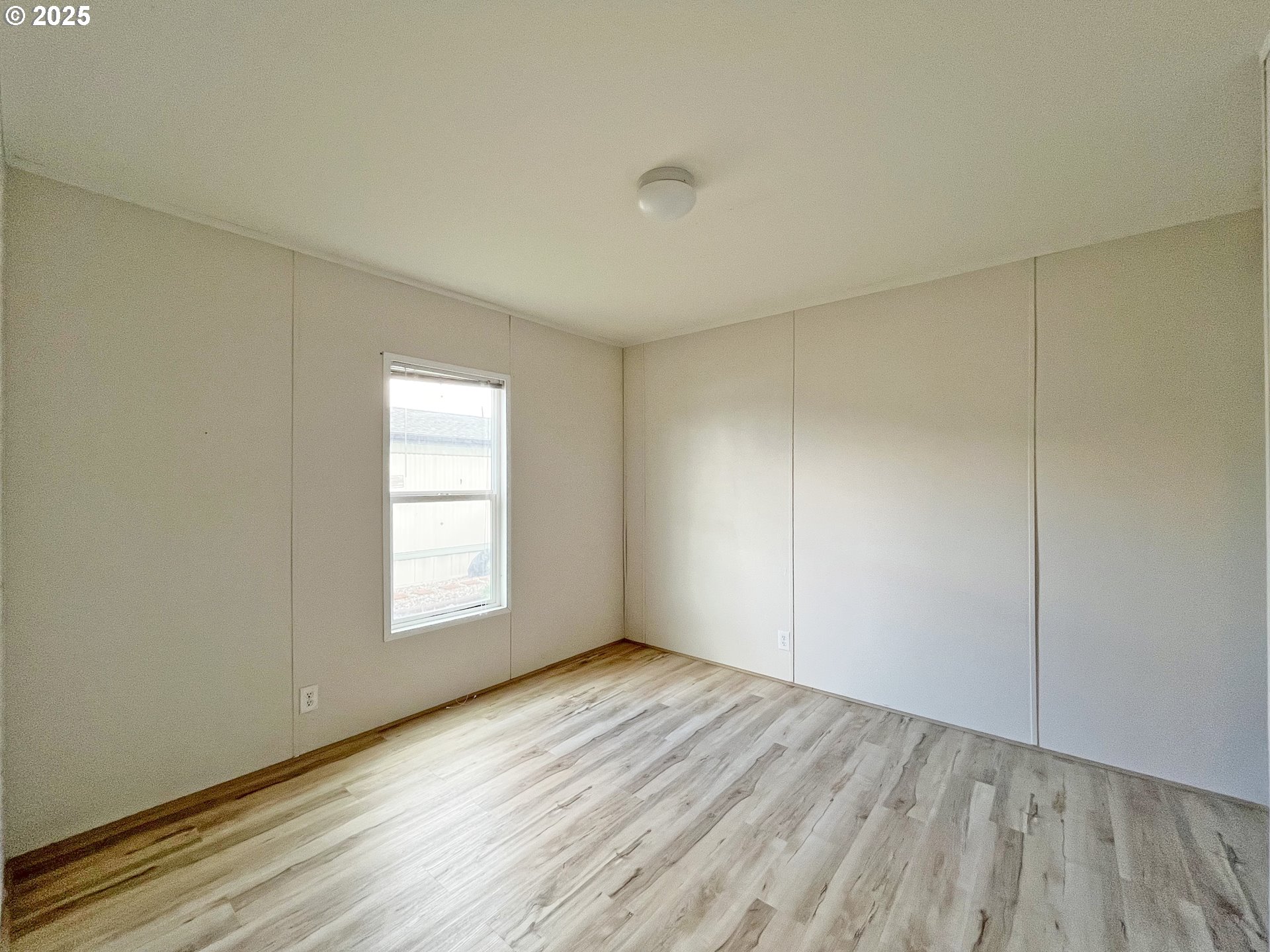 3564 East 2nd Street, Unit 33 The Dalles, OR 97058 - Photo 13 of 15 an empty room with wooden floor and windows
