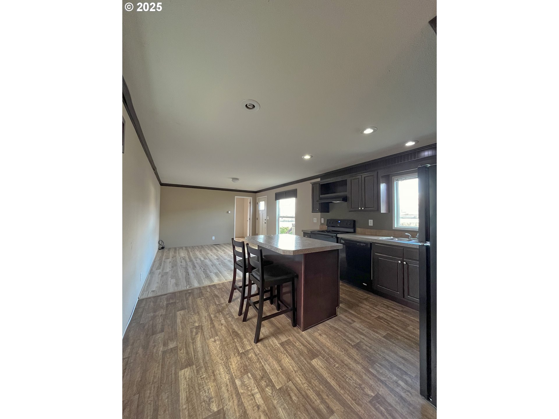 3564 East 2nd Street, Unit 33 The Dalles, OR 97058 - Photo 4 of 15 a view of a dining room with furniture and a kitchen