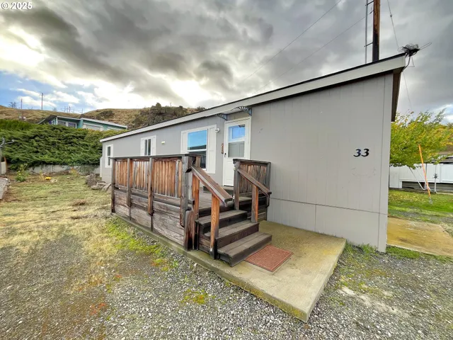 a view of backyard with deck and seating area