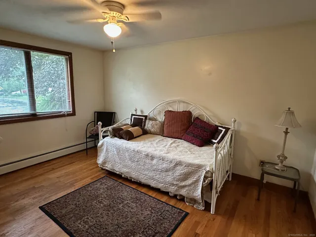 a bedroom with bed and window