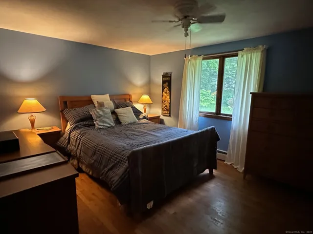 a bedroom with a bed and window