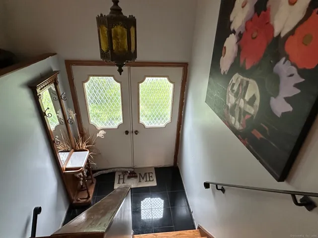 a living room with furniture and a mirror