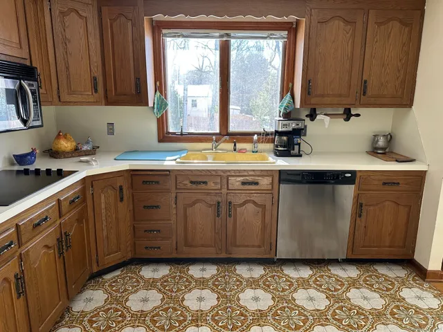 a kitchen with stainless steel appliances granite countertop a sink stove and cabinets