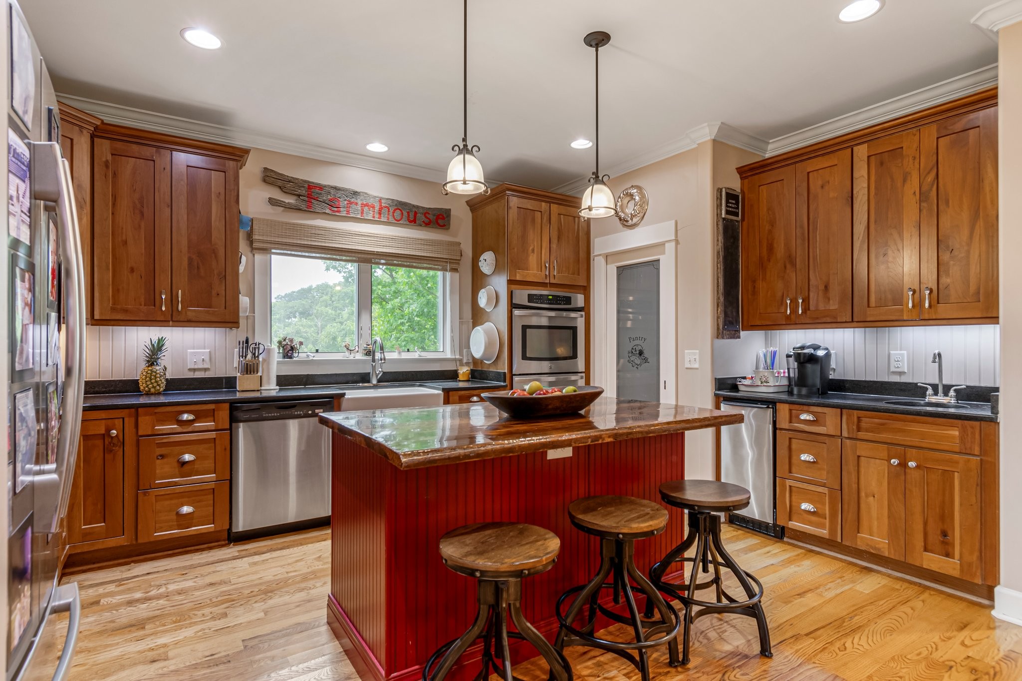 4540 Peytonsville Road Franklin, TN 37064 - Photo 49 of 84 a kitchen with stainless steel appliances granite countertop wooden cabinets a stove a sink a dining table and chairs