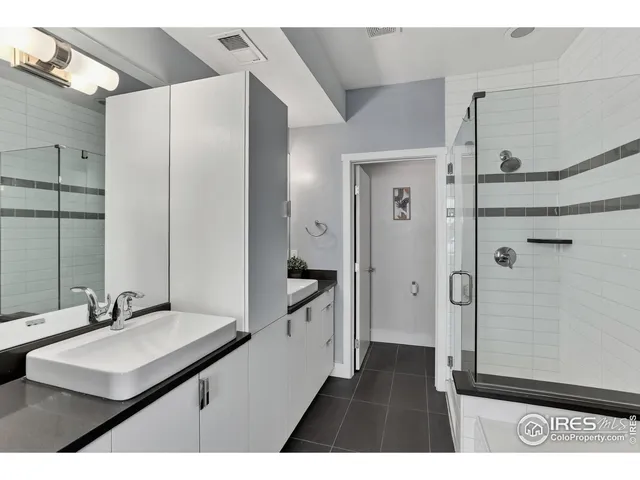 a bathroom with a sink a mirror and a shower