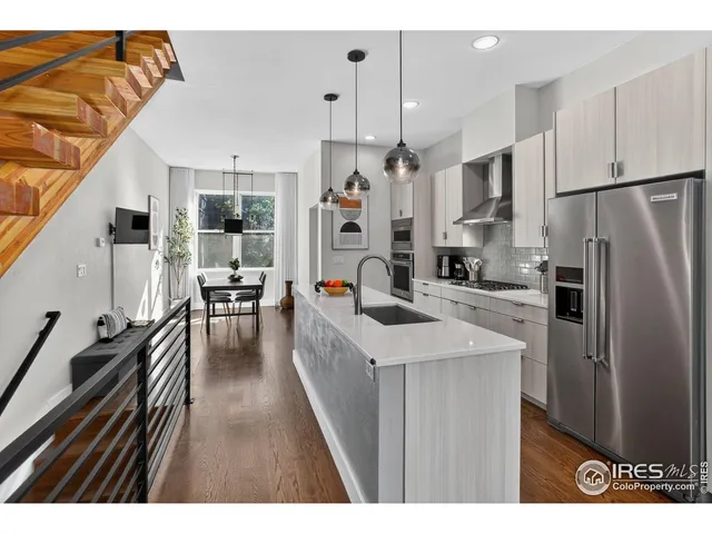 a kitchen with stainless steel appliances a stove a sink dishwasher and a refrigerator