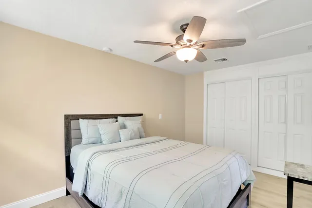 a bedroom with a bed and a chandelier