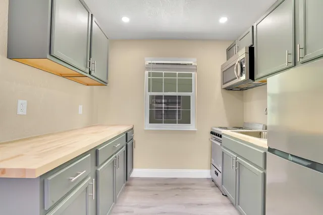 a kitchen with a sink and a refrigerator