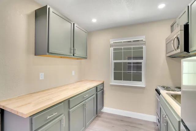 a bathroom with a sink a vanity and a window