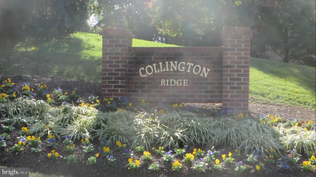 a sign that is sitting in front of flowers