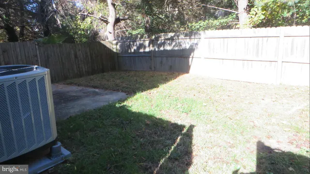 a view of yard with wooden fence