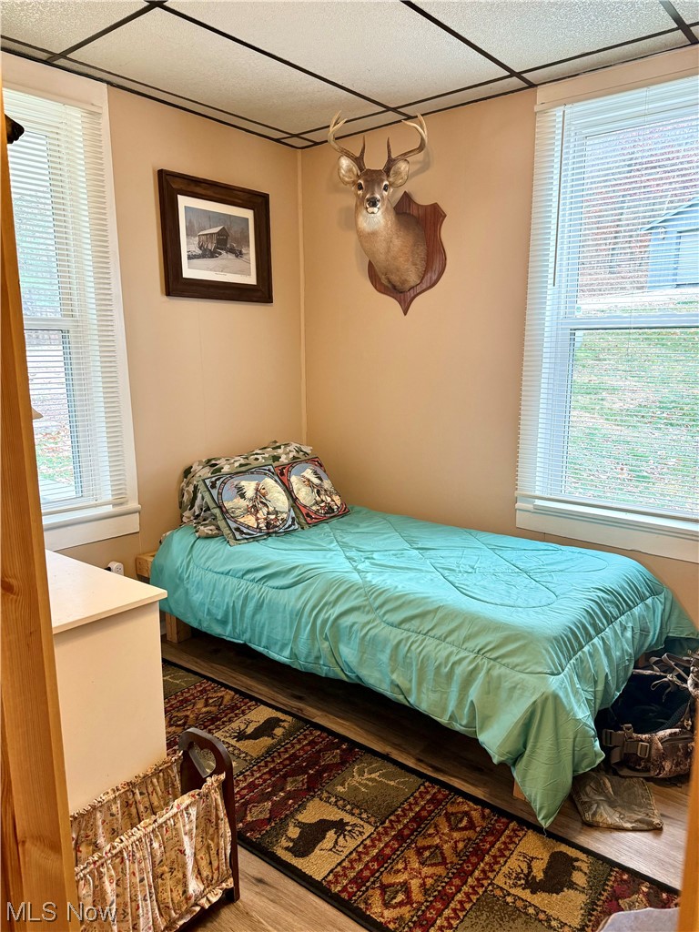 4760 Bird Road Kimbolton, OH 43749 - Photo 14 of 18 Bedroom featuring wood-type flooring and a drop ceiling