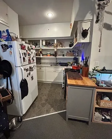 a kitchen with stainless steel appliances a stove a sink and a refrigerator
