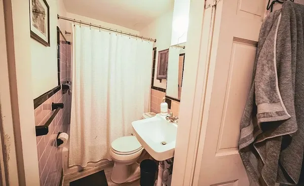 a bathroom with a toilet and a shower