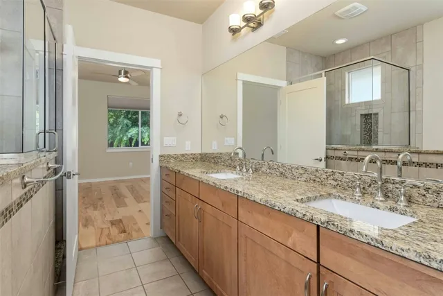a bathroom with a granite countertop sink mirror and double