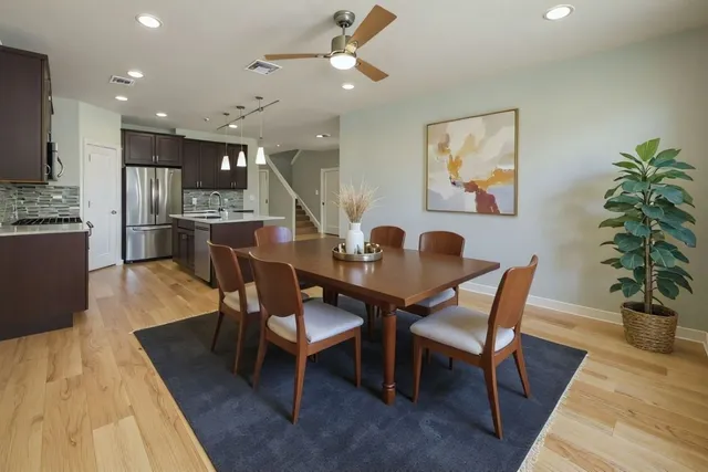 a dining room with furniture a rug and wooden floor