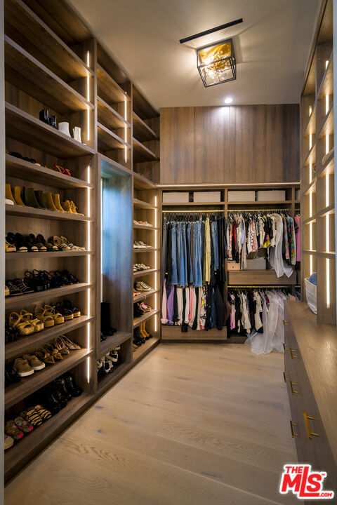 1367 Casiano Road Los Angeles, CA 90049 - Photo 17 of 26 a view of walk in closet with clothes and shoes
