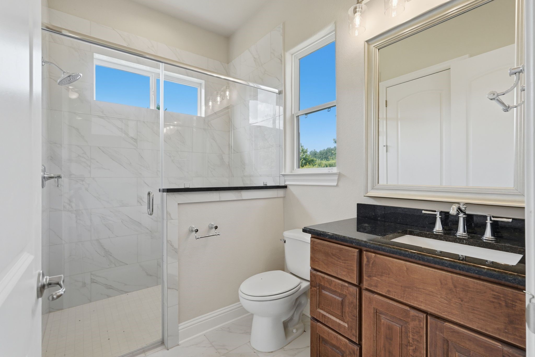 16081 Forest Mill Road Willis, TX 77378 - Photo 34 of 37 Bright and well-appointed, this guest house bathroom offers generous counter space, rich cabinetry, and a full bath perfect for independent living.