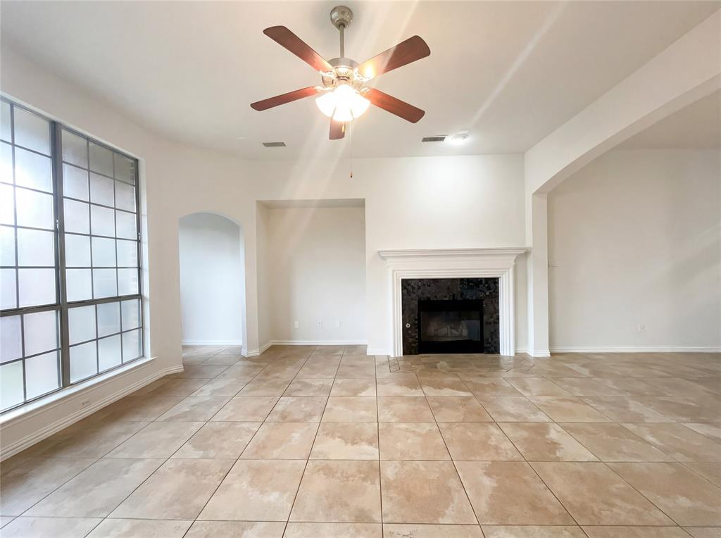 2128 Chambers Drive Allen, TX 75013 - Photo 13 of 23 an empty room with windows and a fireplace